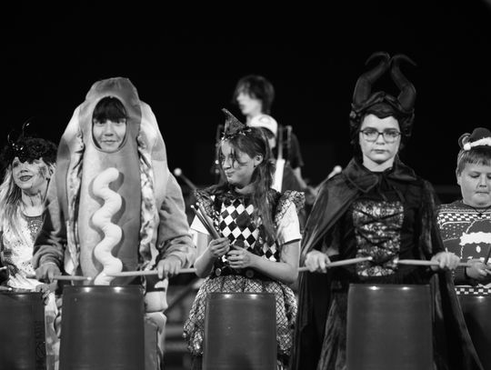 Members of the Chanute Elementary School Bucket Brigade play percussion on buckets during ap erformance with the Chanute High School drumline