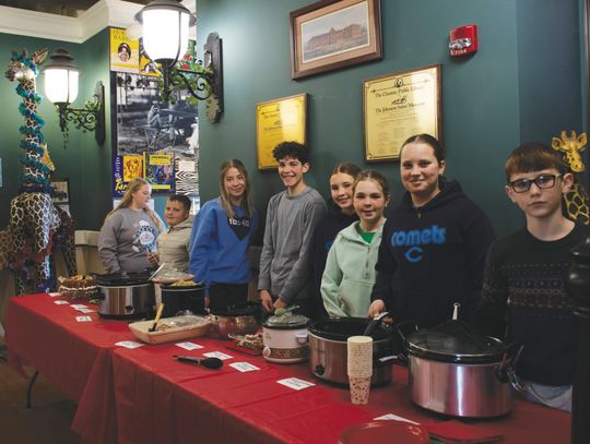 Members of the Neosho Valley Busy Bee 4H Club served the Italian dishes they prepared for the 35th annual International Tasting Tea that they have held with the Safari Museum