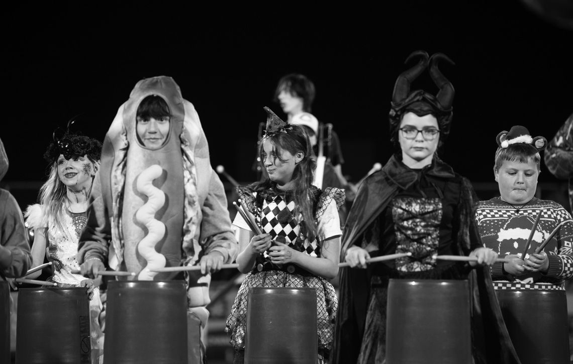 Members of the Chanute Elementary School Bucket Brigade play percussion on buckets during ap erformance with the Chanute High School drumline