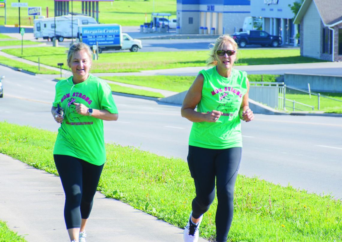 Two participants run near Santa Fe Park during the third annual Chanute Mother’s